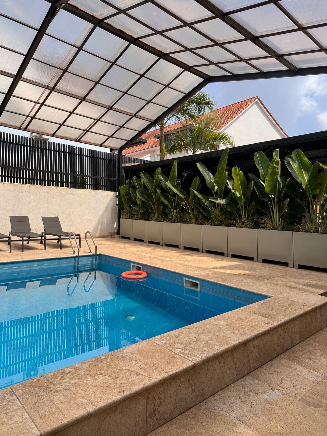 Covered swimming pool with loungers