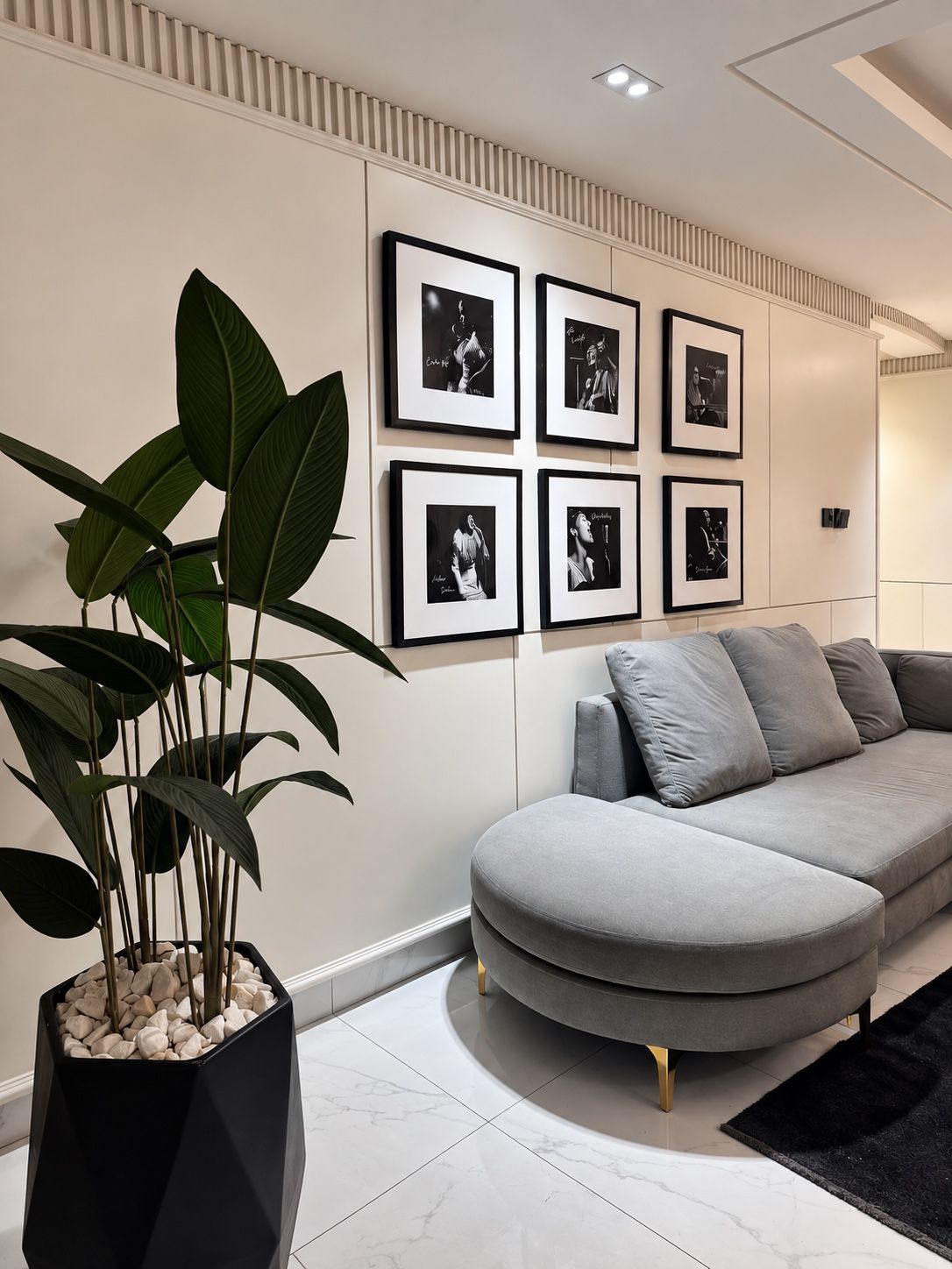 Living area with a framed photography wall and grey sofa